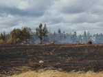 The Field of Serenity, still smoldering, while fire fighters do what they do